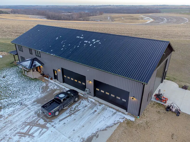 A steel-sided barndominium with attached shop bays near Tomah, Wisconsin